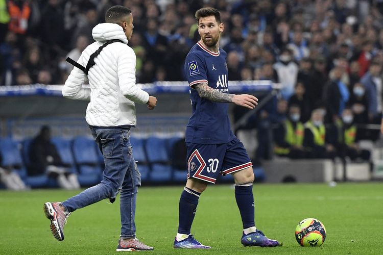 Seorang fan berlari ke arah Lionel Messi di tengah pertandingan Marseille vs Paris Saint-Germain (PSG) di Stadion Velodrome, Senin (25/10/2021) dini hari WIB. 