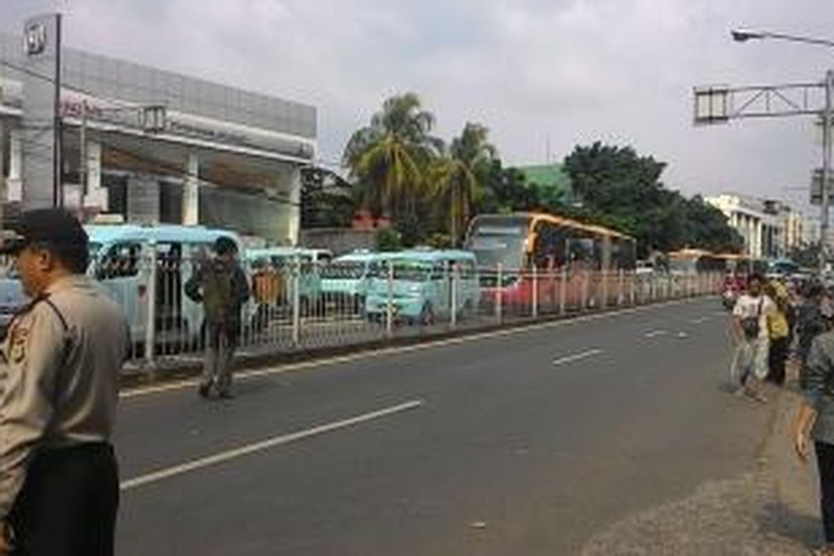 Suana Jalan Jatinegara Barat, Jatinegara,Jakarta Timur pasca demo warga Kampung Pulo. Seorang aparat polisi terlihat berjaga di ruas jalan tersebut. Rabu (10/6/2015).