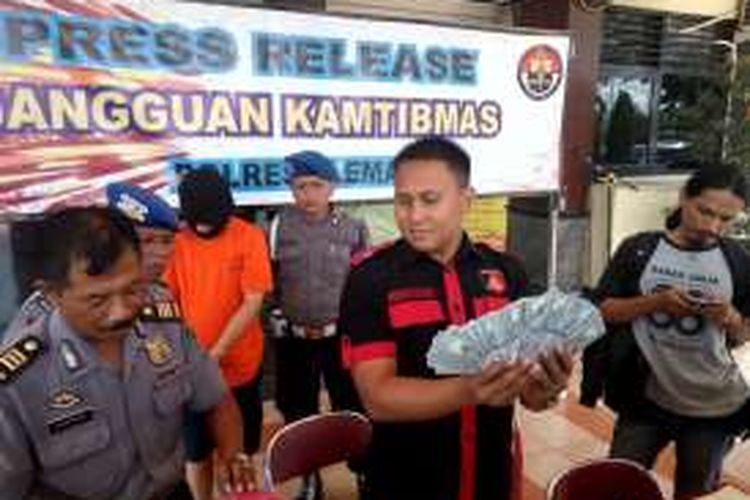 Kasat Reskrim Polres Sleman AKP Sepuh Siregar saat menunjukan uang dolar yang menjadi barang bukti