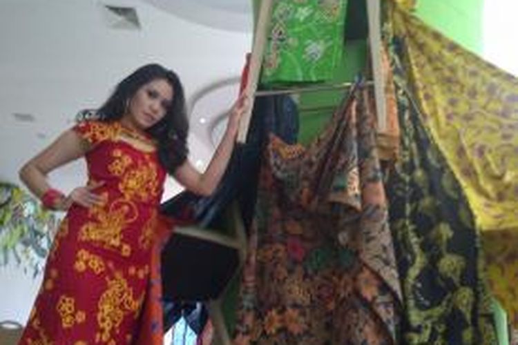 Seorang model lokal Malang, Jawa Timur, saat memperagakan batik celaket di bawah rakitan kursi yang sindir penguasaa yang sibuk rebutan kursi. Acara tersebut memperingati hari batik nasional 2 Oktober 2014.Kamis (2/10/2014).
