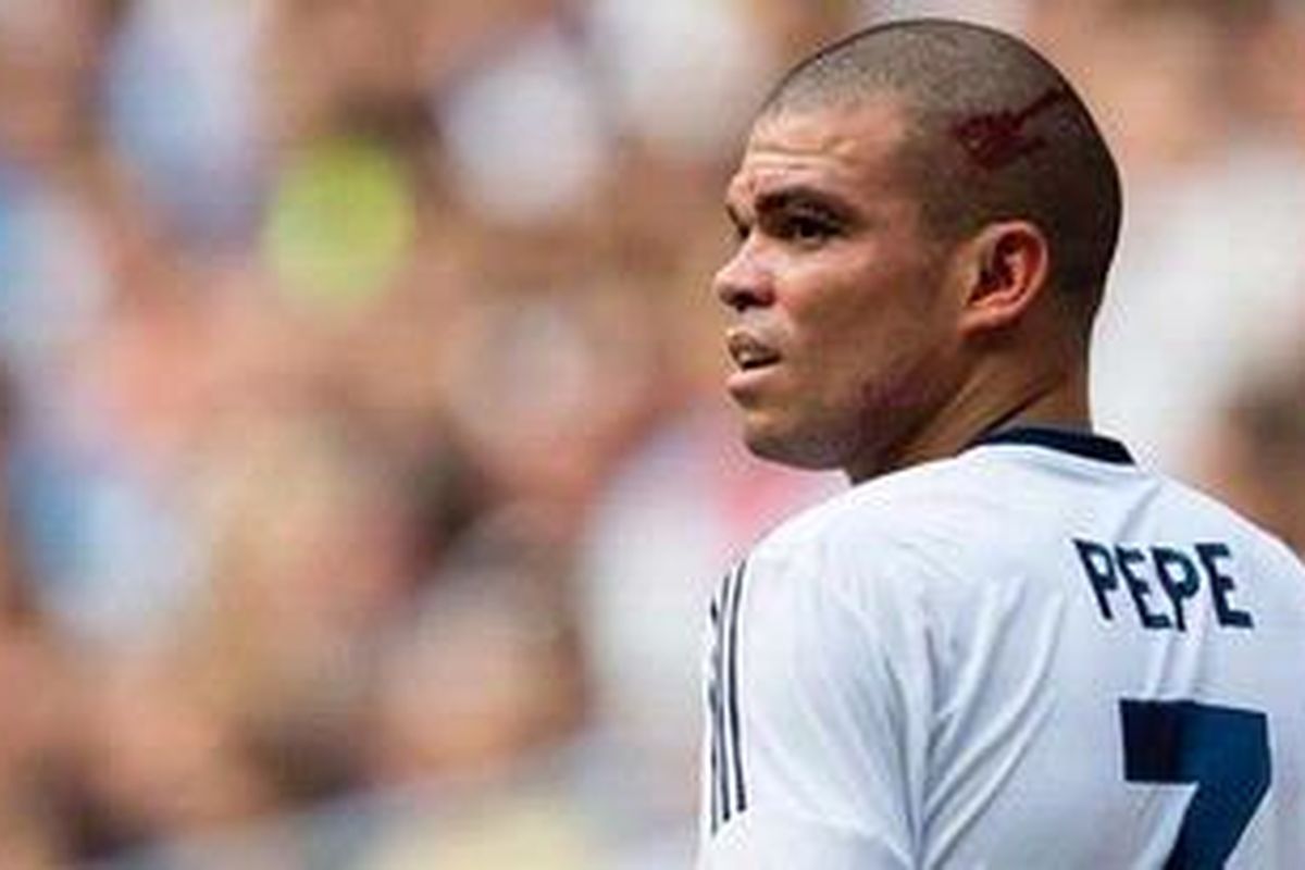 Bek Real Madrid dari Portugal, Pepe, berdiri dengan luka di kepalanya menyusul benturan dengan kiper Iker Casillas dan gelandang Xabi Alonso saat melawan Valencia dalam laga perdana Liga BBVA 2012/13 di Santiago Bernabeu, Minggu (19/8/2012). Madrid dan Valencia akhirnya bermain imbang 1-1. Pepe dilarikan ke rumah sakit akibat cedera kepalanya itu.