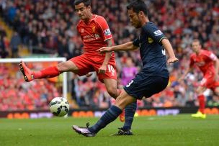 Bek Southampton, Maya Yoshida (kanan) saat berusaha mengamankan bola dari kawalan gelandang Liverpool, Coutinho, pada laga Premier League di Stadion Anfield, Minggu (17/8/2014). 