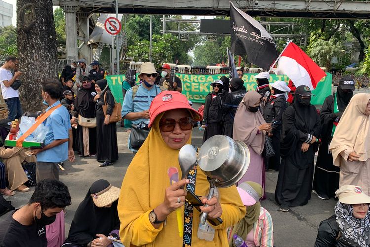 Peserta aksi bernama Ida membawa atribut seperti panci serta spatula sebagai bentuk protes atas naiknya harga BBM di kawasan Patung Kuda, Jakarta Pusat, Jumat (23/9/2022).