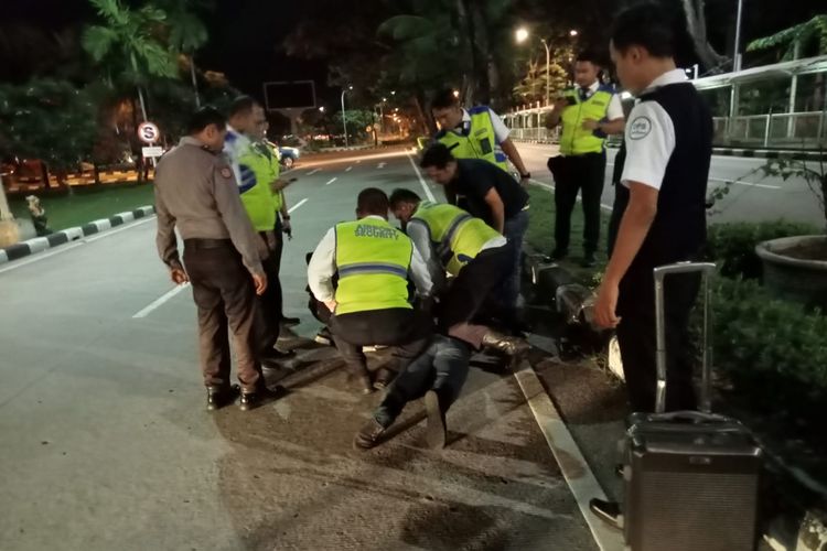 Petugas gabungan saat mengamankan pria warga negara Filipina berinisial JPMP, lantaran mengamuk di Terminal Kedatangan Internasional Bandara I Gusti Ngurah Rai, Badung Bali, pada Kamis (7/12/2023) dini hari. /