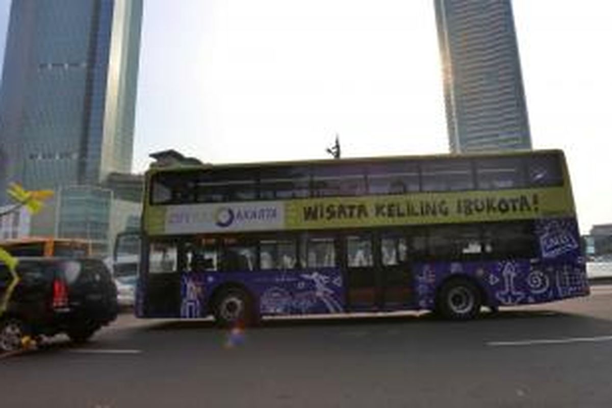 Bus tingkat wisata melintas di Bundaran Hotel Indonesia, Jakarta Pusat, Selasa (18/2/2014). Kelima bus tingkat wisata itu tengah diujicoba berjalan menyusuri rute yang akan ditempuh. Rencananya Senin (24/2/2014) bisa dinikmati warga Jakarta.