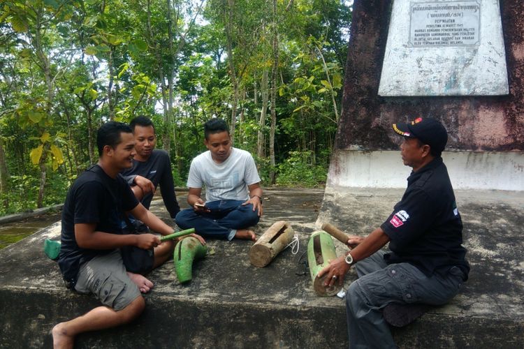 Sesepuh desa Bejiharjo, Karangmojo, Gunungkidul, Tukijo Memperlihatkan cara Memukul Kentongan kepada Anak Muda di desanya, saat Persiapan Menyambut Gerhana bulan Nanti malam di Monumen Serangan Belanda di dusun Gelaran