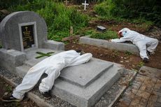 BERITA FOTO: Tenaga Pikul Beristirahat di Atas Makam Usai Kuburkan Jenazah Pasien Covid-19