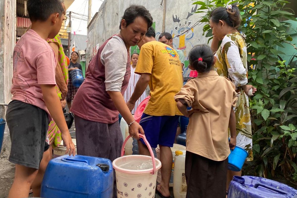 Warga di Pegadungan, Kalideres, Jakarta Barat mengangkut air karena krisis air bersih, Rabu (13/9/2023). 