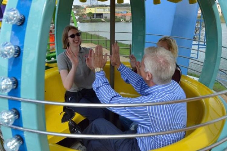 Morgan dan orang tuanya menikmati wahana permainan roda Ferris di taman hiburan Morgans Wonderland.