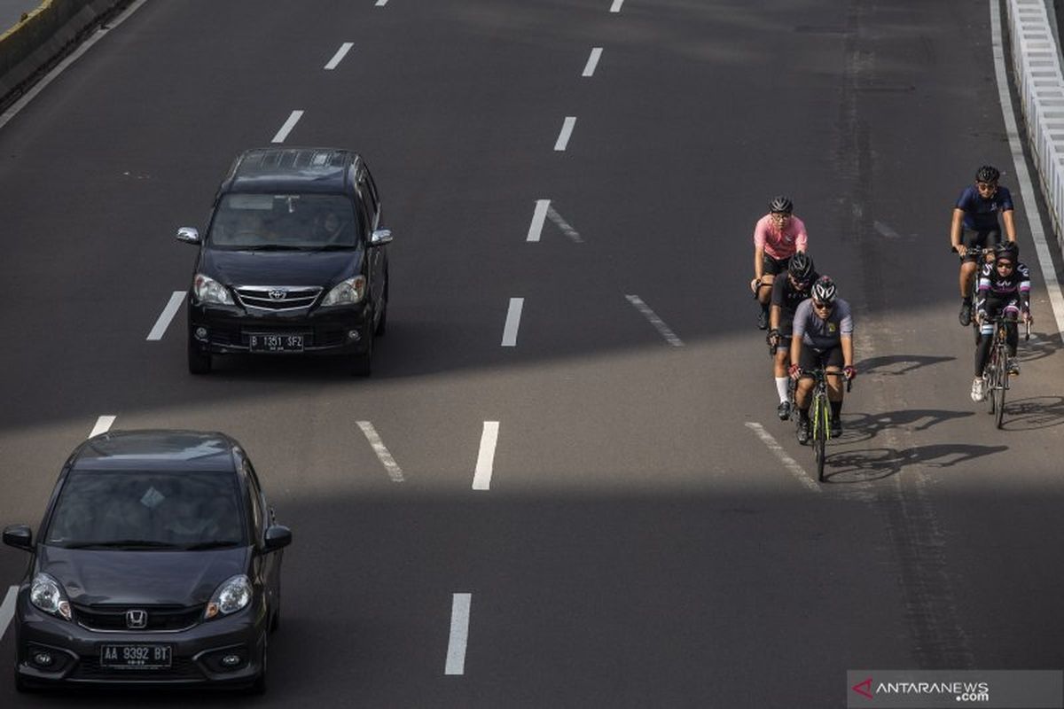 Pesepeda memacu kecepatan saat melintas di Jalan Jenderal Sudirman, Jakarta, Minggu (30/5/2021). 