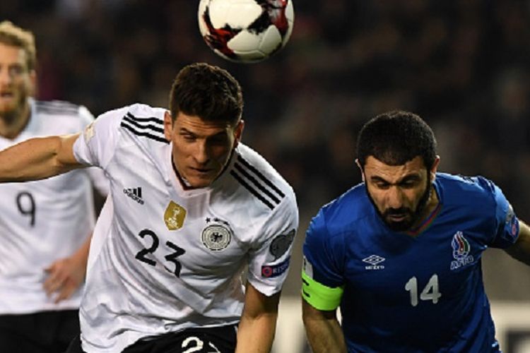 Mario Gomez (putih) and Rashad F. Sadygov (biru) berebut bola di udara saat Jerman bertandang ke markas Azerbaijan pada Kualifikasi Piala Dunia 2018, Minggu (26/3/2017). 