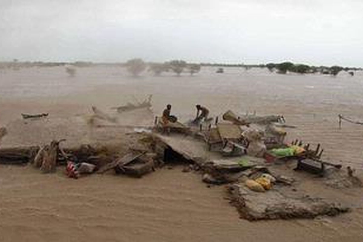 Terjebak: Korban terpaksa bertahan di atap rumah yang terendam banjir di Taunsa Sharif, Pakistan saat banjir telah menewaskan sekitar 1.100 orang di negara itu.