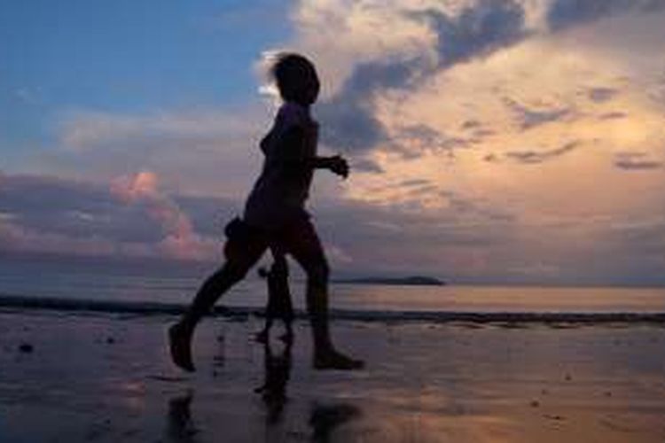 Anak-anak bermain di Pantai Barawai, Papua.