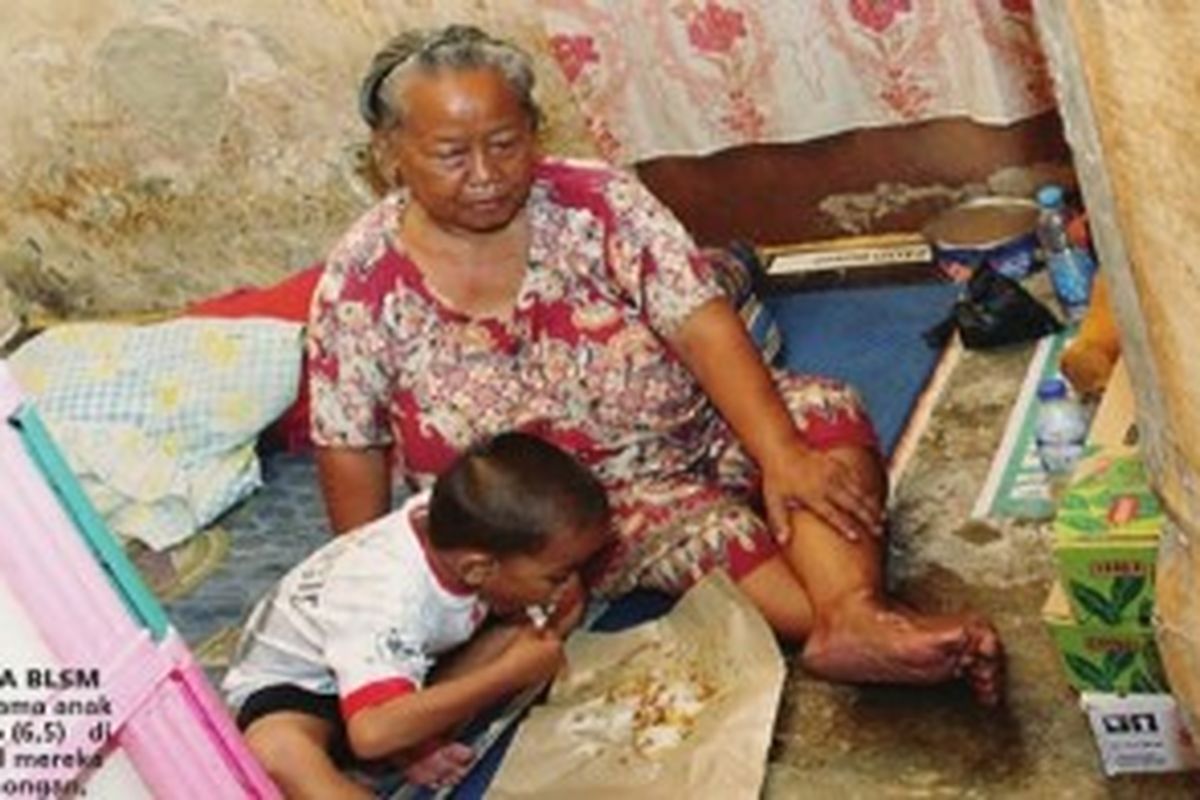 Yoyon (62) bersama anak angkatnya, Eko (6,5) di tempat tinggal mereka di Pecenongan, Gambir, Jakarta Pusat, Selasa (2/7/2013). Janda miskin ini tidak termasuk dalam daftar penerima BLSM.