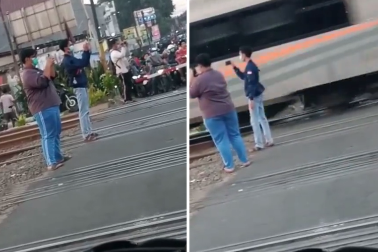 Tangkapan layar video yang menampilkan railfans, sebutan penggemar kereta api, sedang merekam momen kereta melintas dengan berdiri di tengah rel.