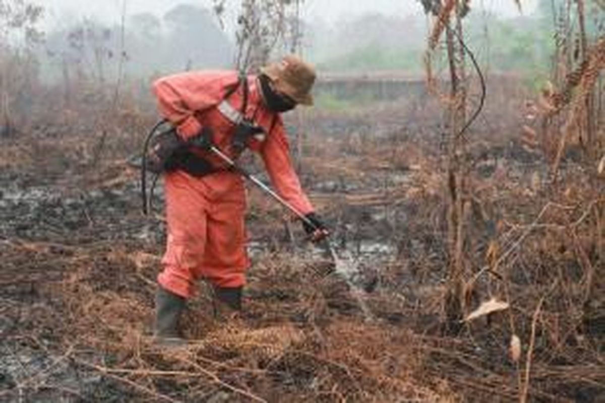 Anggota Manggala Agni Daops Singkawang melakukan pemadaman kebakaran hutan gambut di Desa Telok Ampening, Kecamatan Terentang, Kabupaten Kubu Raya, Kalbar, Jumat (25/9/2015).