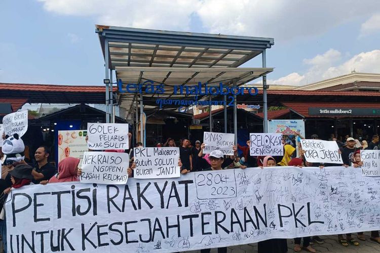 Para pedagang menunjukkan tanda tangan petisi di depan Teras Malioboro 2, Rabu (17/7/2024)