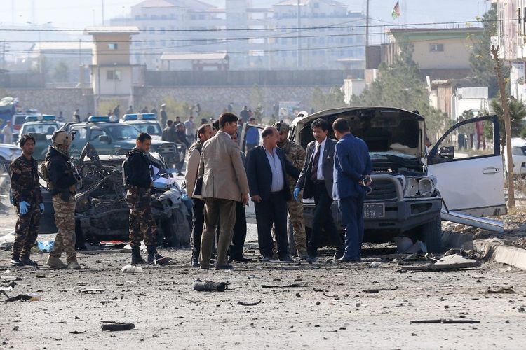 Security personnel and investigators gather at the site of a suicide attack in Kabul on November 13, 2019. - At least seven people were killed and seven wounded when a car bomb detonated during Kabuls busy morning rush hour on November 13, an interior ministry spokesman said. (Photo by STR / AFP)