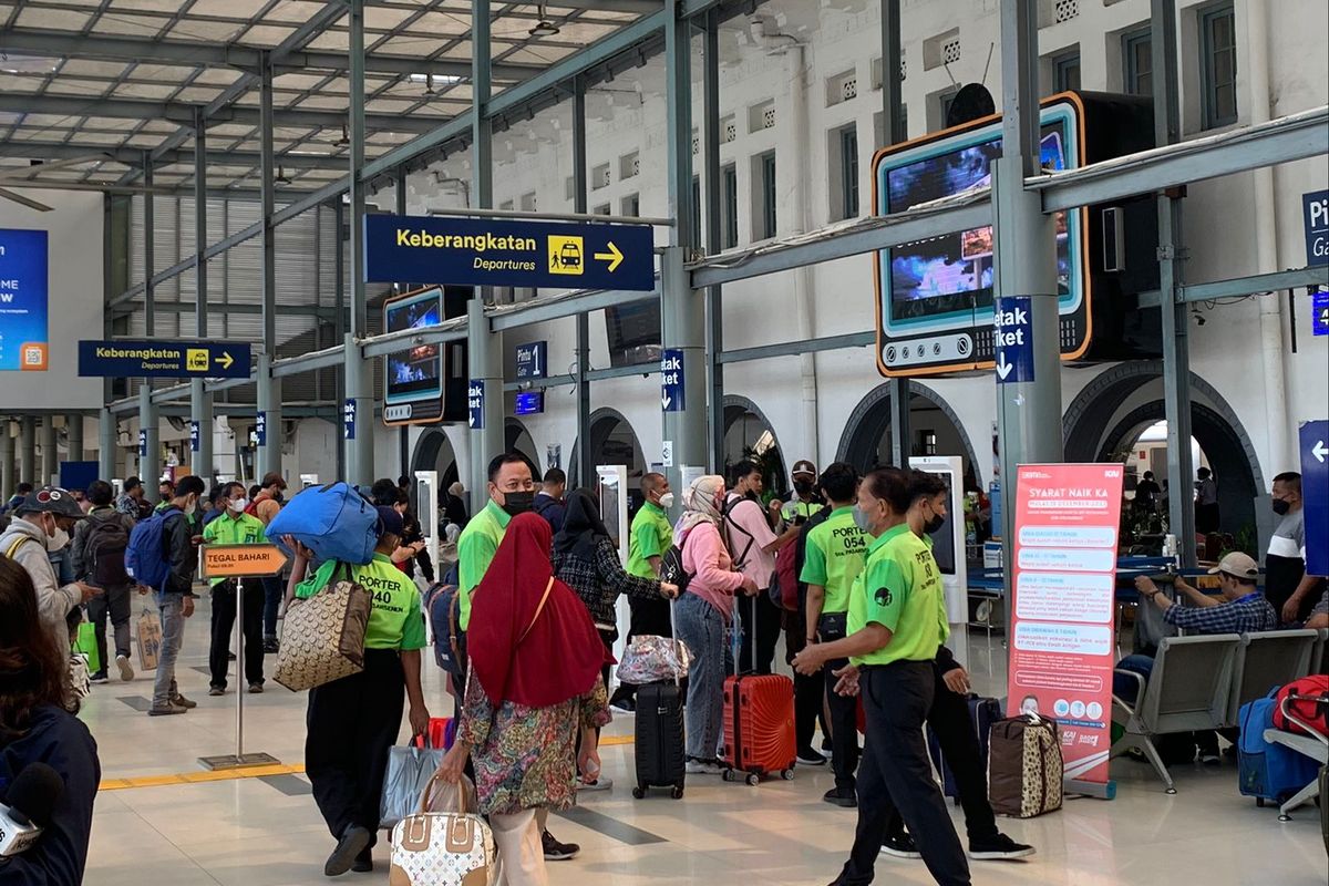 Pekerja jasa kuli angkut (porter) yang bekerja membawakan barang-barang penumpang kereta api di Stasiun Pasar Senen, Jakarta Pusat, Senin (13/3/202).