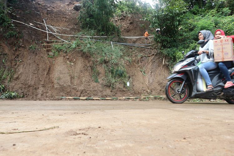 Tampak warga melintasi jalur Pacet-Trawas, Kabupaten Mojokerto, Jawa Timur, pada Sabtu (8/2/2020). Sebelumnya jalur ini putus akibat longsor setinggi 5 meter dan selebar 12 meter, Jumat petang kemarin.