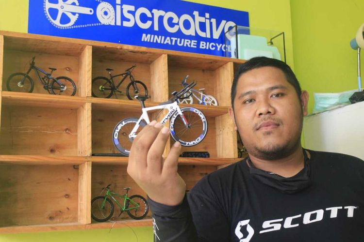 Yudi Hermawan, salah satu pemuda yang tergabung dalam Aiscreative_miniaturbicyle menunjukkan miniatur sepeda buah tangan mereka.