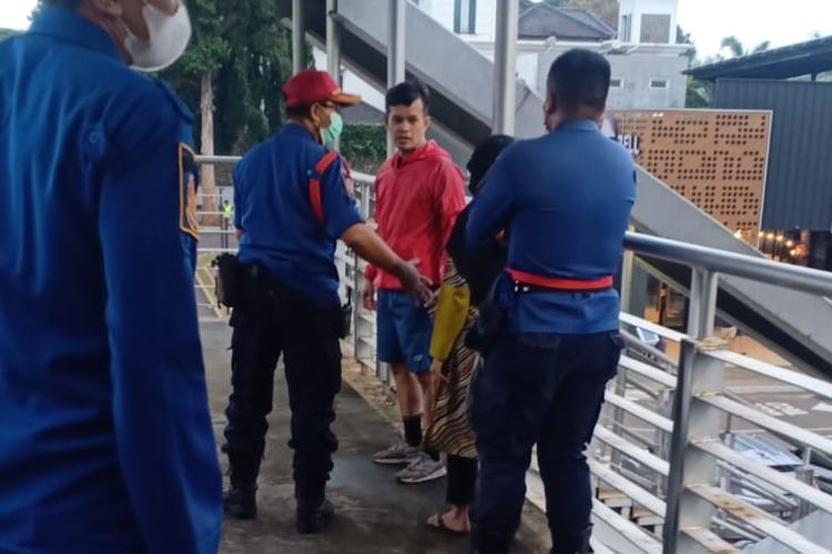 Petugas Sudin Gulkarmat Jakarta Barat berupaya gagalkan upaya bunuh diri yang dilakukan F (35) di JPO Jalan Arteri, Kebon Jeruk, Jakarta Barat, Selasa (2/3/2022).