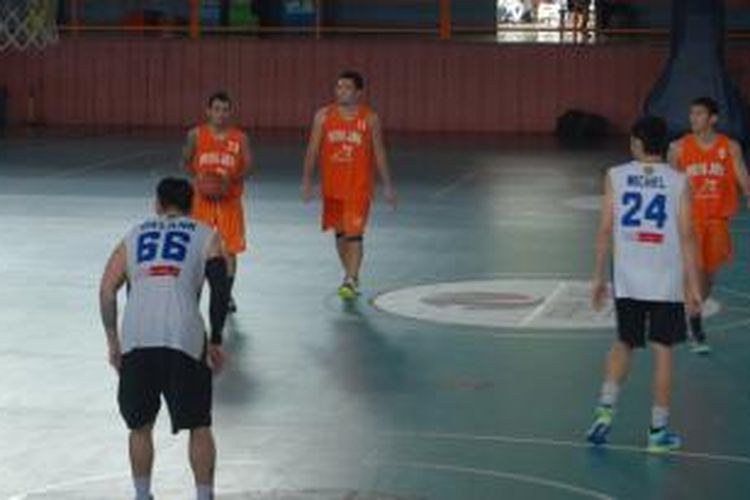 Pelita Jaya Energi-MP (jersey oranye), menguasai bola dan hendak melakukan serangan pada Satria Muda BritAma pada pertandingan uji coba di Hall Basket, Senayan, Selasa (10/9/2013)./