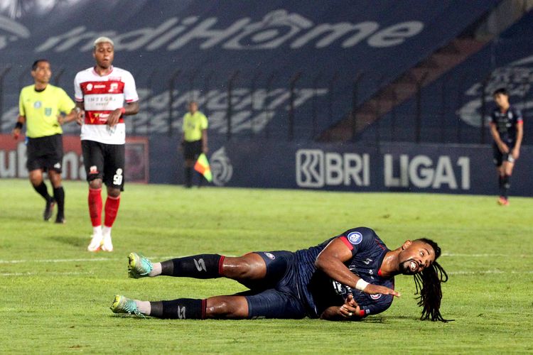 Pemain Arema FC Carlos Fortes terjatuh seusai berebut bola dengan pemain Madura United pada pekan 10 Liga 1 2021 yang berakhir dengan skor 1-2 di Stadion Sultan Agung Bantul, Senin (1/11/2021) malam.