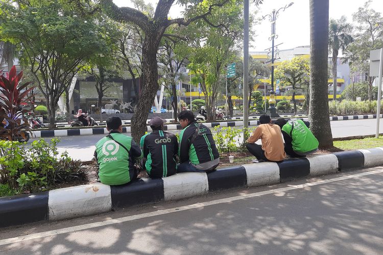 Sejumlah pengemudi ojol sedang menunggu penumpang di depan Mall CCM, Cibinong, Kabupaten Bogor, Jawa Barat, Selasa (1/7/2025).