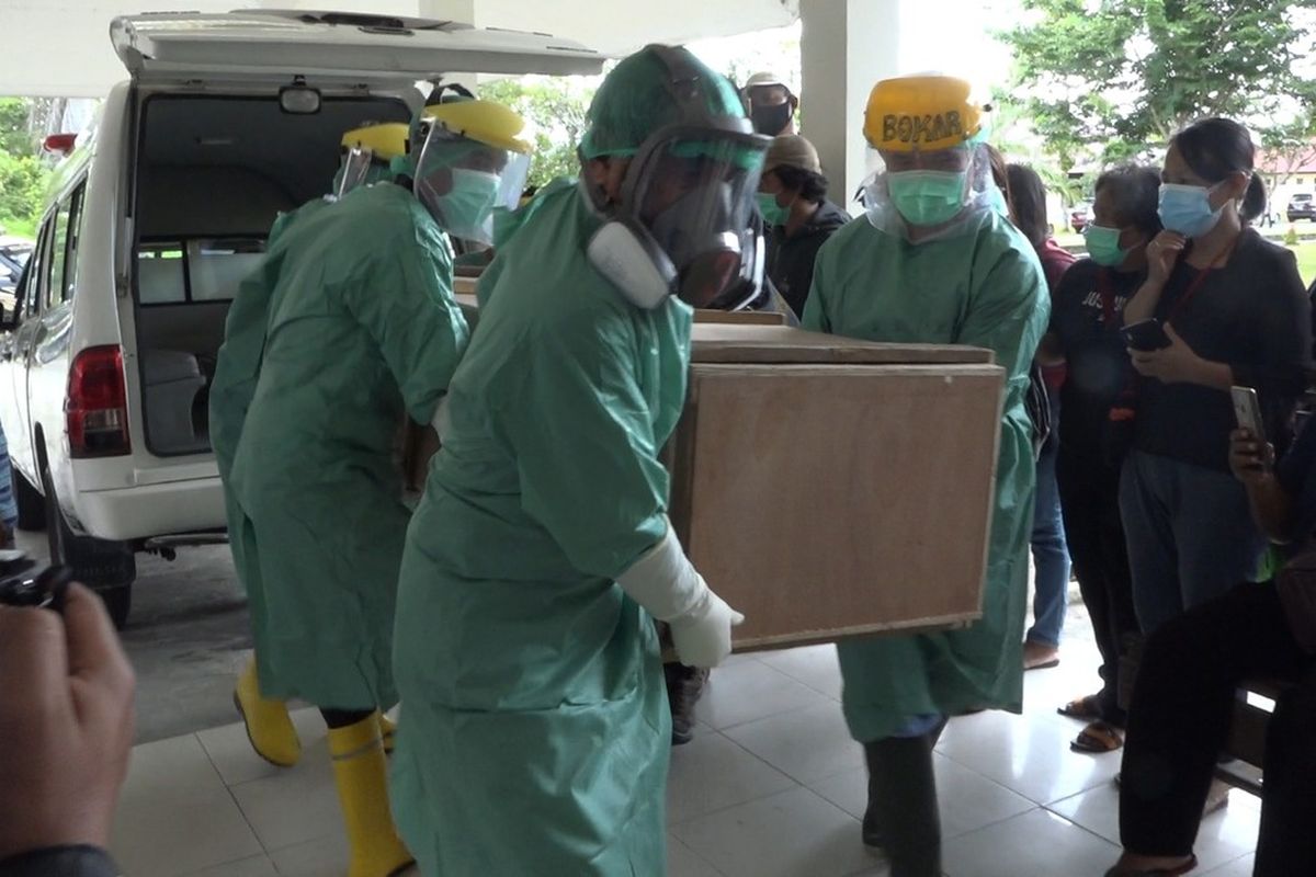 Coroners offload the remains of Oktovianus Rayo, one of two teachers killed by Papuan insurgents at Puncak regency's Beoga district on Saturday (10/4/2021)