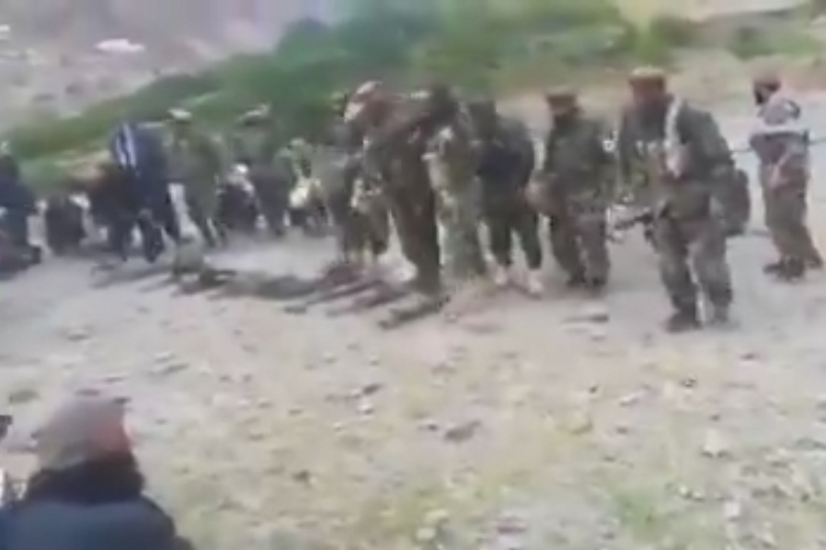 Tangkapan layar dari sebuah video yang diduga sejumlah tentara Afghanistan menyerahkan senjata kepada Talibah di seuatu tempat di Afghanistan.