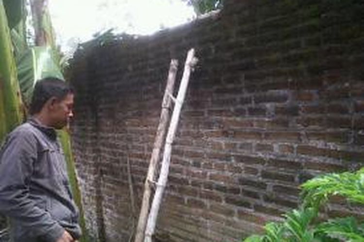 Perampok menggunakan tangga untuk memanjat pagar tembok yang mengelilingi rumah Johadi, juragan sapi di Blitar, Jawa Timur, Kamis (21/11/2013).