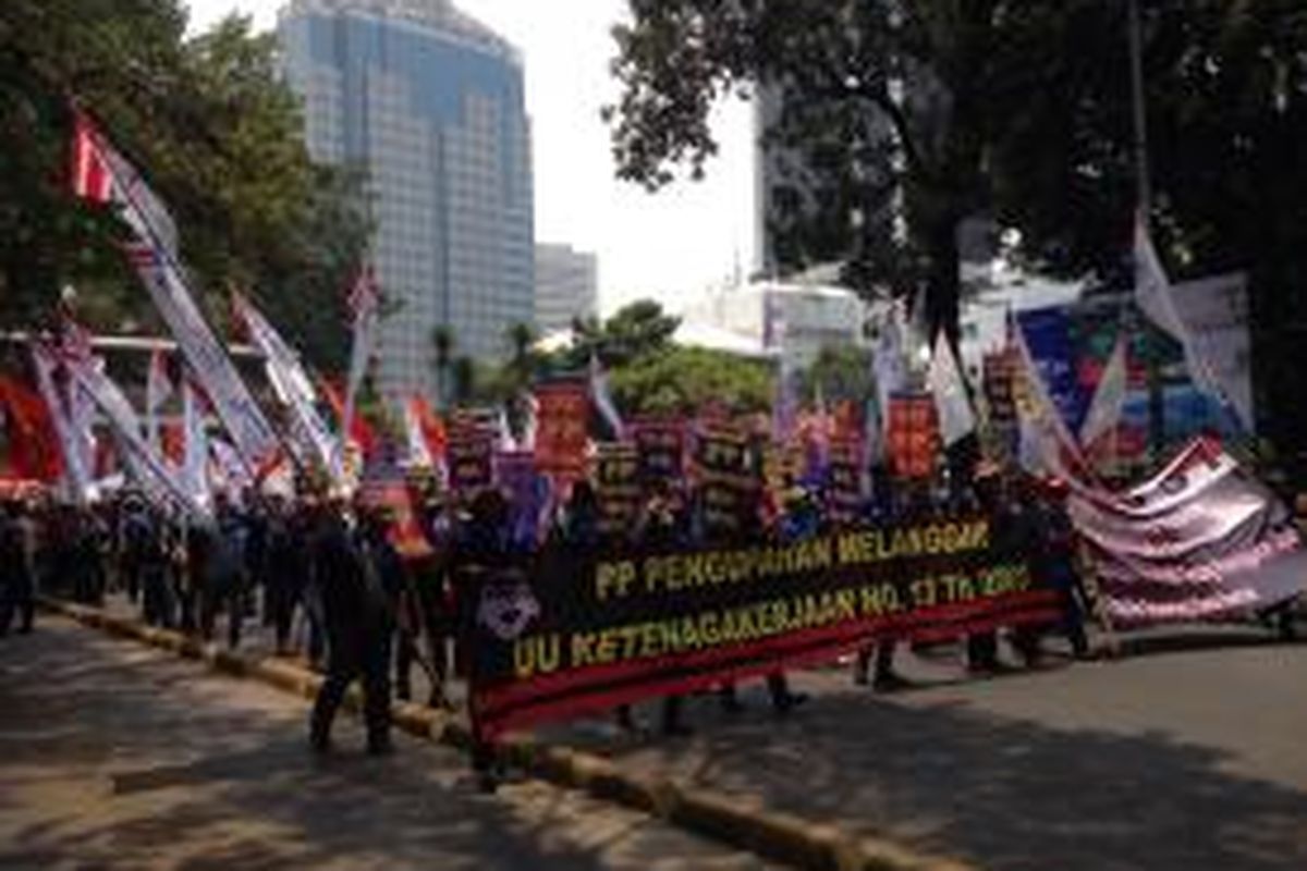 Massa buruh KSBSI terlihat berjalan dari Jalan Medan Merdeka Utara menuju Istana Negara pada Rabu (28/10). 