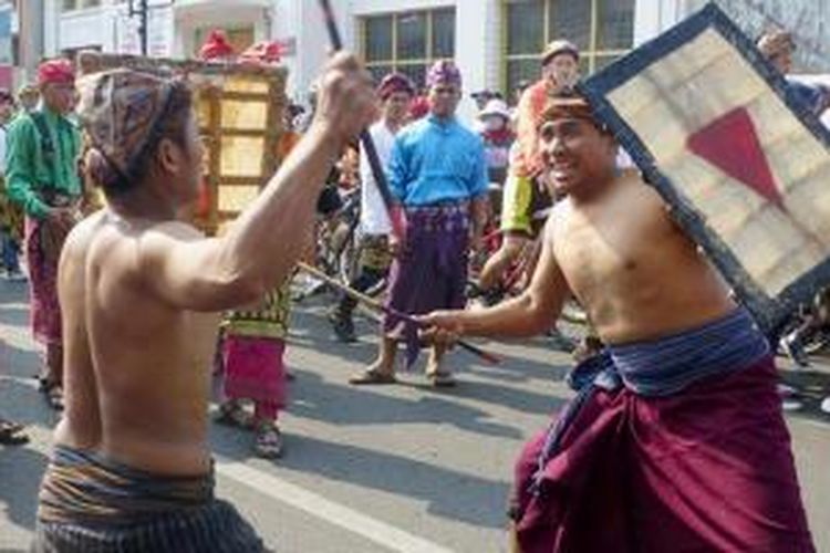 Dua laki-laki menampilkan atraksi budaya Presean dalam prosesi parade budaya yang merupakan rangkaian acara pembuka dalam Festival Lombok Sumbawa 2015, Minggu (4/10/2015), di Gedung Merdeka, Kota Bandung, Jawa Barat. Presean merupakan salah satu seni bela diri di Pulau Lombok.