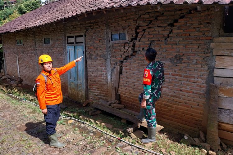Petugas menunjukkan rumah salah satu warga Dukuh Nguncup, Desa Bekiring, Kecamatan Pulung, Kabupaten Ponorogo, Jawa Timur retak setelah dihantam tanah gerak, Kamis (30/3/2023).