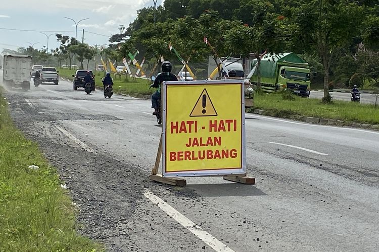 Kondisi Jalan Terusan Ryacudu yang berlubang, Kamis (13/4/2023).