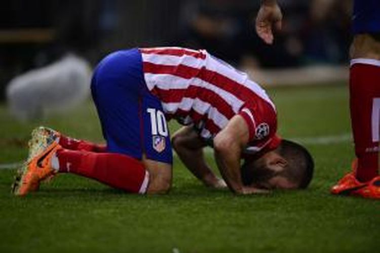 Gelandang Atletico Madrid Arda Turan merayakan golnya ke gawang AC Milan, pada leg kedua 16 besar Liga Champions, di Vicente Calderon, Selasa (11/3/2014).