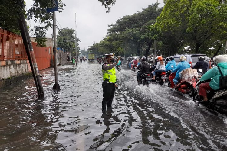 Sebuah genangan air setinggi hingga 40 sentimeter terjadi saat hujan deras di Jalan Daan Mogot, Jakarta Barat, pada Sabtu (5/2/2022) siang.