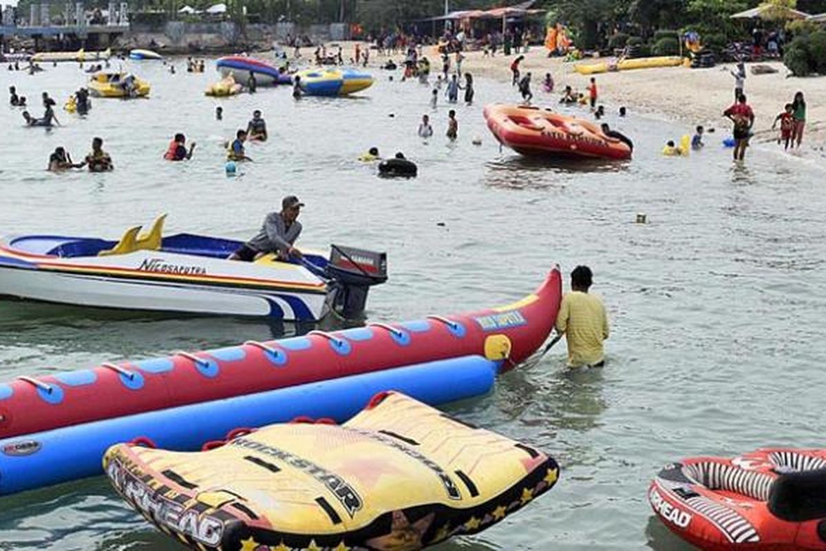 Pengunjung memadati pantai di Pulau Untung Jawa, Kepulauan Seribu, Minggu (12/4/2015). Pulau Untung Jawa menjadi tujuan wisatawan lokal karena letaknya yang relatif dekat dengan Jakarta dan Tangerang.