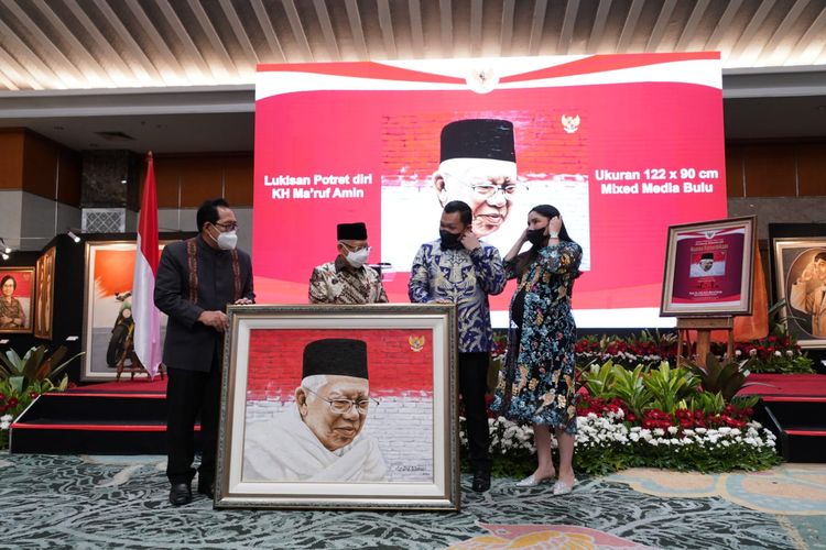 Wakil Presiden Ma'ruf Amin berfoto dengan lukisan bergambar potret dirinya yang laku dilelang dengan nilai Rp 1,5 miliar dalam acara Malam Pagelaran Seni Lukis Nuansa Kemerdekaan di Grand Sahid Jaya Hotel, Jakarta, Senin (22/8/2022). 
