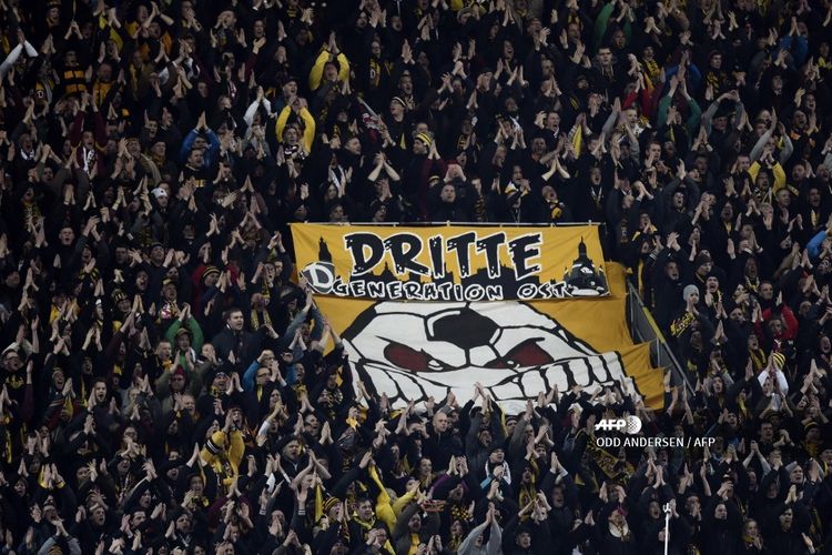 Dresdens fans wave around a giant banner reading Third generation East before the start of the German football Cup DFB Pokal round of 16 game between German third division Dynamo Dresden and first Bundesliga Borussia Dortmund, in Dresden eastern Germany, on March 3, 2015.