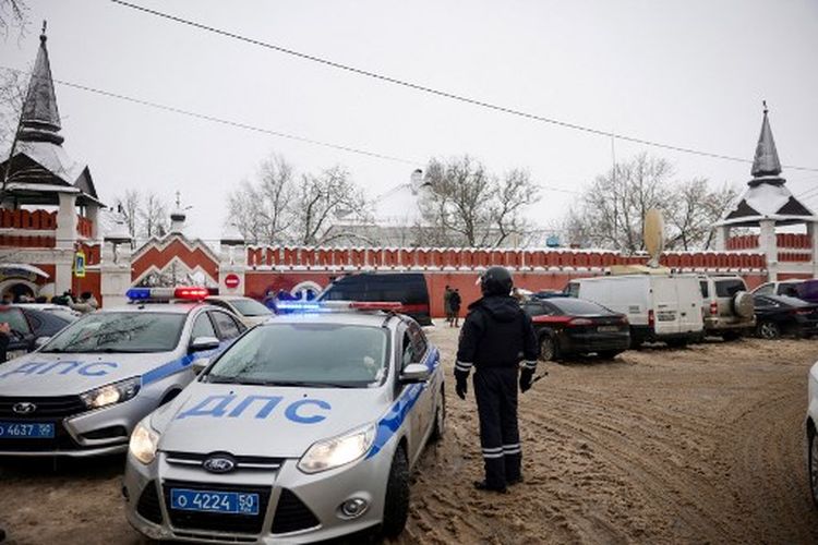 Seorang petugas polisi lalu lintas mengontrol lalu lintas di depan biara Vvedenskiy Vladychniy setelah seorang lulusan gimnasium Ortodoks yang berusia 18 tahun memasuki sekolah dan meledakkan dirinya, di kota Serpukhov, 100 kilometer (60 mil) selatan Moskow, pada 13 Desember 2021. 