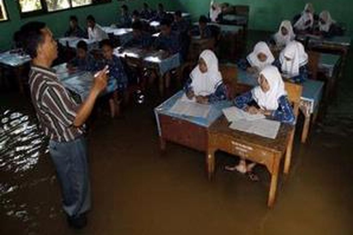 Ilustrasi: Suasana belajar di sebuah sekolah yang kebanjiran.