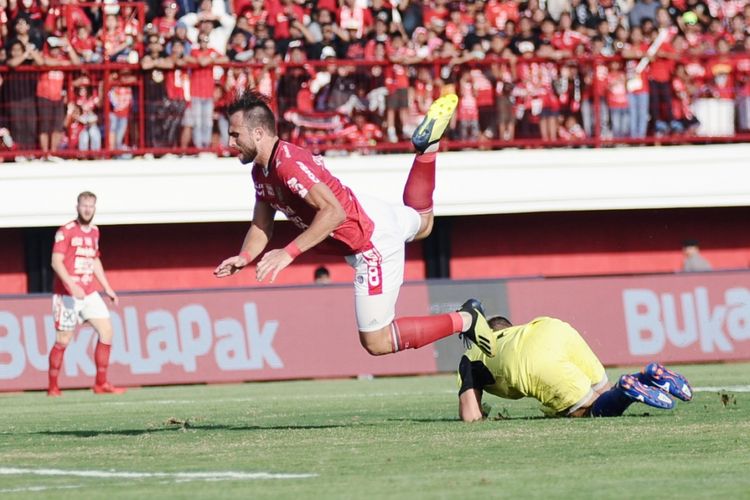 Ilija Spasojevic dijegal kiper pengganti Persela, M.Ridwan saat kedua tim berlaga di Stadion Kapten I Wayan Dipta Gianyar, Selasa (11/9/2018)