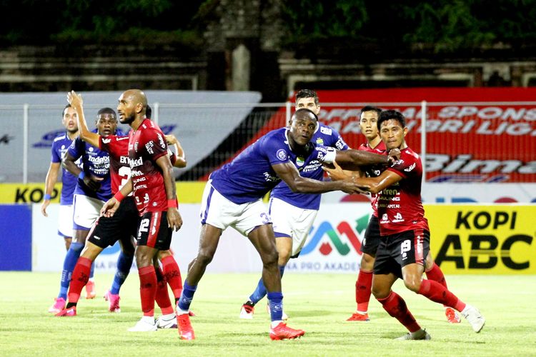 Pemain Persib Bandung Victor Igbonefo siap berduel dengan pemain Bali United Rizky Pellu pada pertandingan pekan 19 Liga 1 2021-2022 yang berakhir dengan skor 0-1 di Stadion I Gusti Ngurah Rai Denpasar, Kamis (13/1/2021) malam.