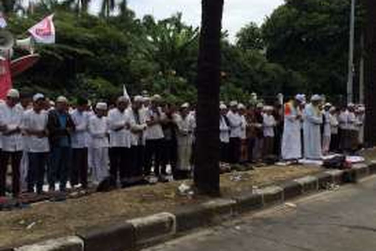 Massa pengunjuk rasa sidang kasus dugaan penodaan agama dengan terdakwa Basuki Tjahaja Purnama atau Ahok menggelar salat dzuhur di depan Kementerian Pertanian, Jalan RM Harsono, Jakarta Selatan, Selasa (3/1/2017). Para pengunjuk rasa yang tergabung dalam Gerakan Nasional Pengawal Fatwa (GNPF) itu membentuk shaf di lokasi unjuk rasa.