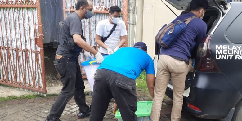 Polisi membawa sejumlah boks berisi kertas-kertas usai melakukan olah tempat kejadian perkara (TKP) satu keluarga yang tewas di dalam sebuah rumah di Citra Garden 1, Kalideres, Jakarta Barat, Minggu (13/11/2022) siang.