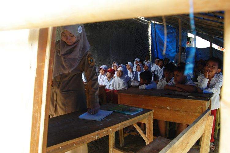 Sejumlah murid Sekolah Dasar Negeri (SDN) Sirna Asih, di Kampung Cisarua, Desa Banyu Resmi, Kecamatan Cigudeg, Kabupaten Bogor, sedang mengikuti kegiatan belajar-mengajar, Jumat (10/2/2017). Selama enam tahun, mereka terpaksa belajar di bawah tenda dan beralaskan tanah karena tidak adanya sekolah di sana.