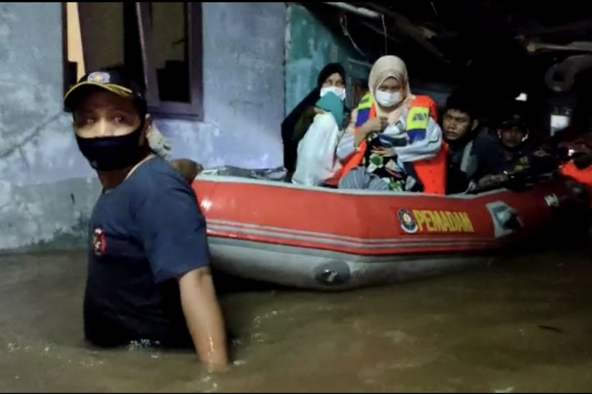 petugas pemadam kebakaran dari Suku Dinas Penanggulangan Kebakaran dan Penyelamatan (Sudin Gulkarmat) Jakarta Selatan Sektor V Cilandak mengevakuasi bayi prematur bersama orangtuanya menggunakan perahu karet di Jalan Kemang Selatan XII, Cipete Selatan, Cilandak, Jakarta, Senin (5/10/2020) dini hari.