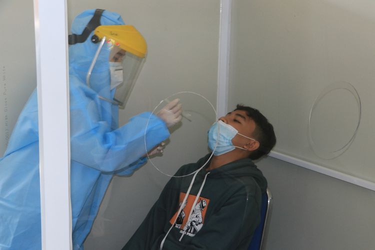 A file photo of a passenger who is undergoing PCR test at the Bandung Train Station in Bandung, West Java. 